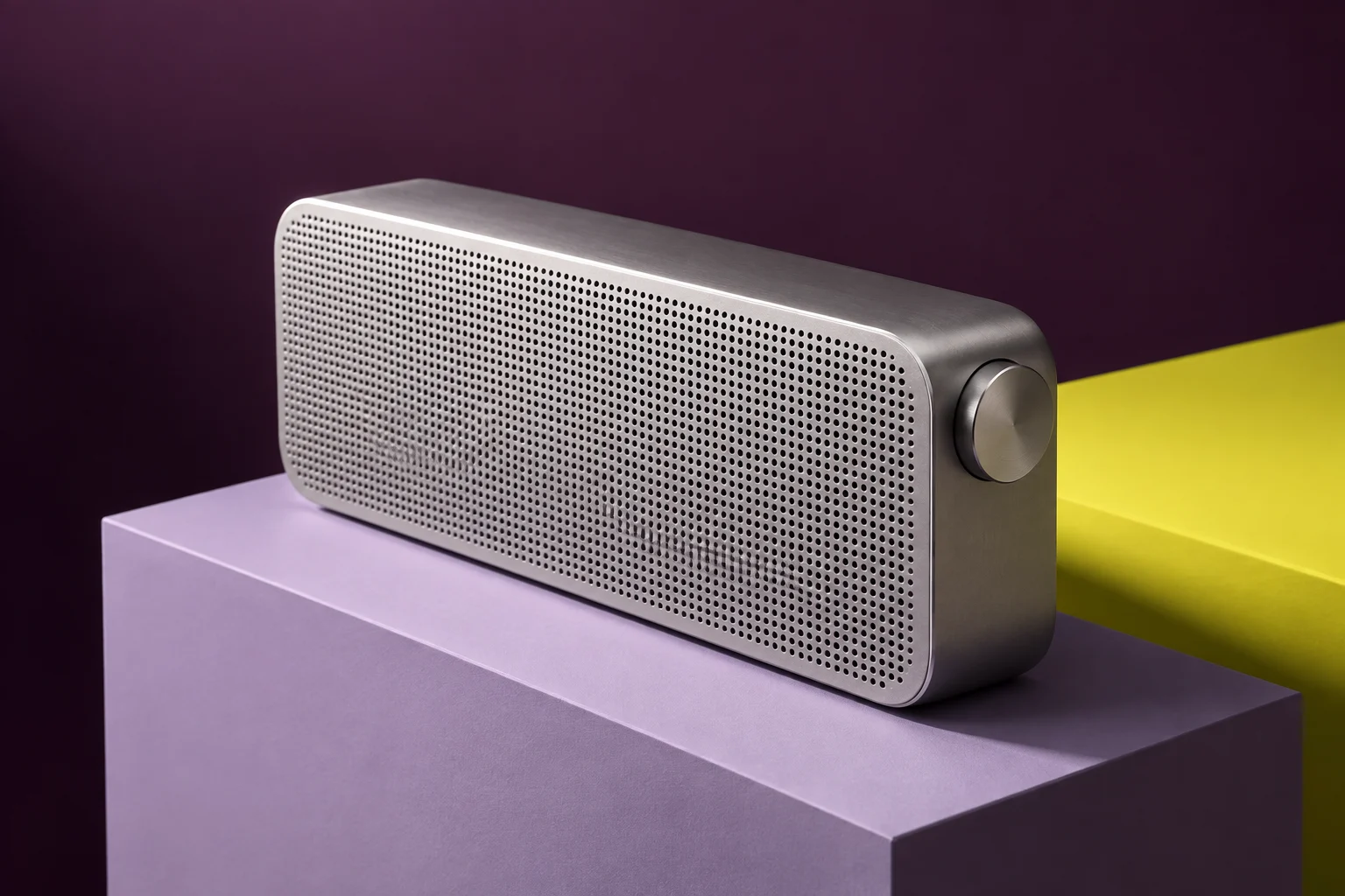 Unbranded aluminum speaker on a lavender and yellow sculptural set